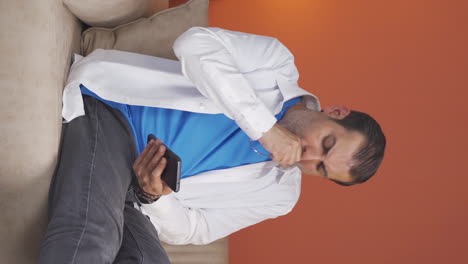 Vertical-video-of-Sick-man-coughing.